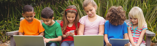 Image of young children using laptops, tablets and mobile phones: Thinkstock